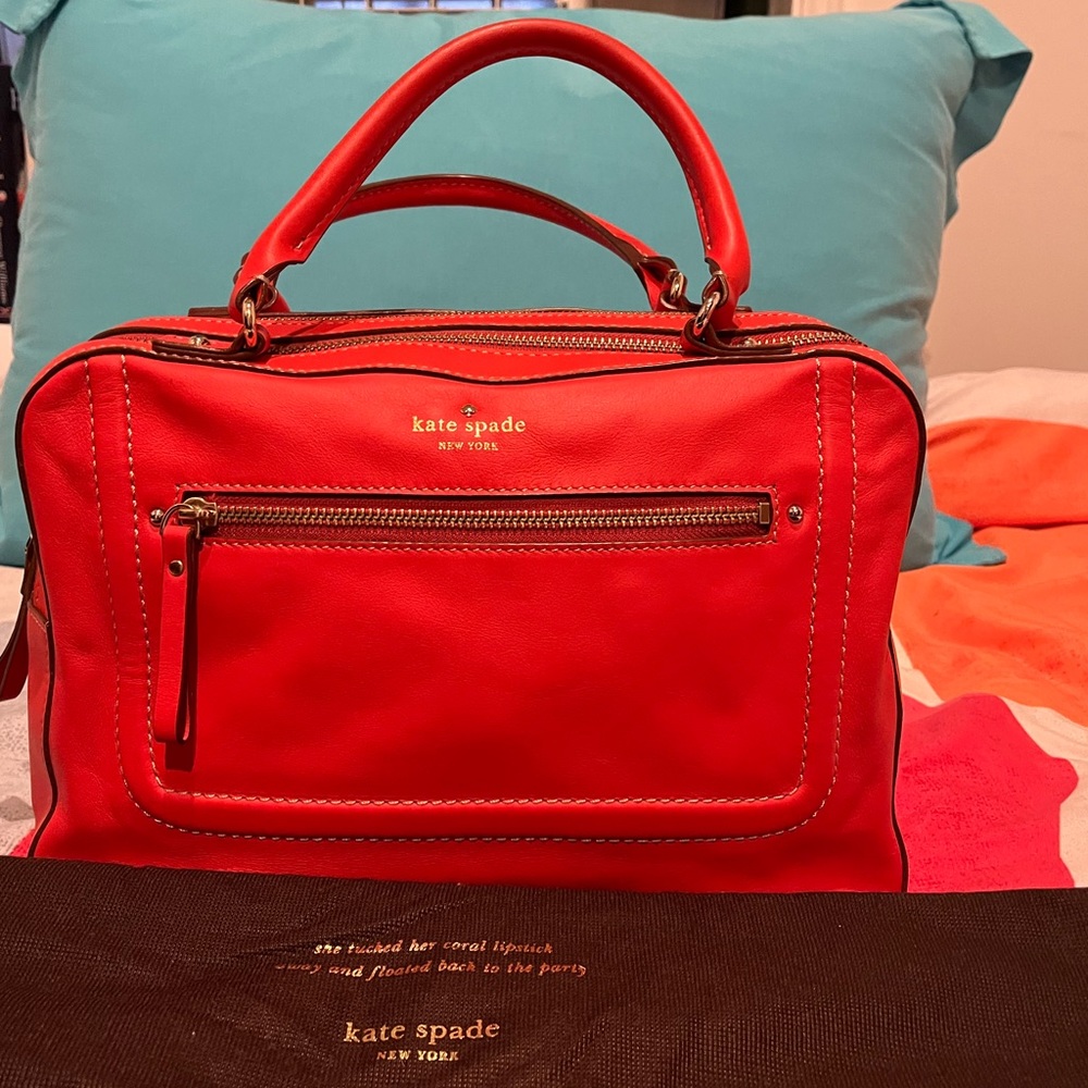 Kate Spade orange leather zippered-top bag with double handles.